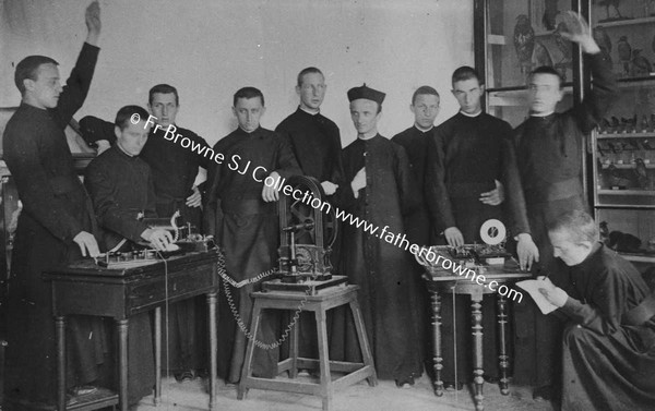 GROUP OF S.J. PRIESTS INCL SELF  WITH SCIENTIFIC APPARATUS